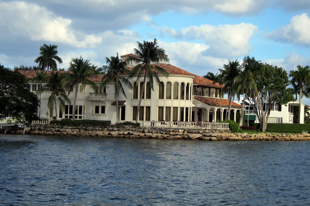 The white Wave Wall along Fort Lauderdale Beach, with palms and the Atlantic beyond