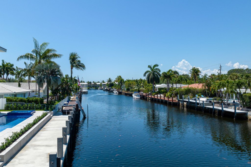 Aerial view of the Intracoastal Waterway at Lighthouse Point, with boats, docks and waterfront homes reaching toward the ocean