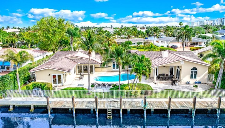 5531 NE 31st Ave — waterfront residence with pool and dock seen from the water