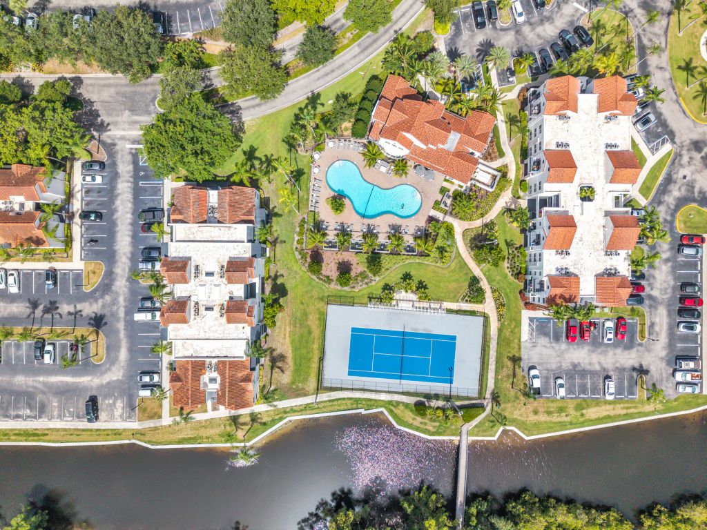 Aerial view of the community pool, clubhouse and tennis courts