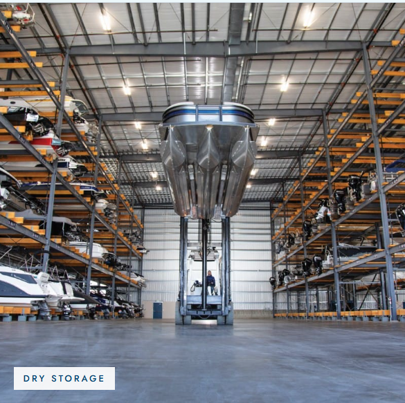 Boats on indoor dry-stack storage racks being moved by a forklift at E Z Marina